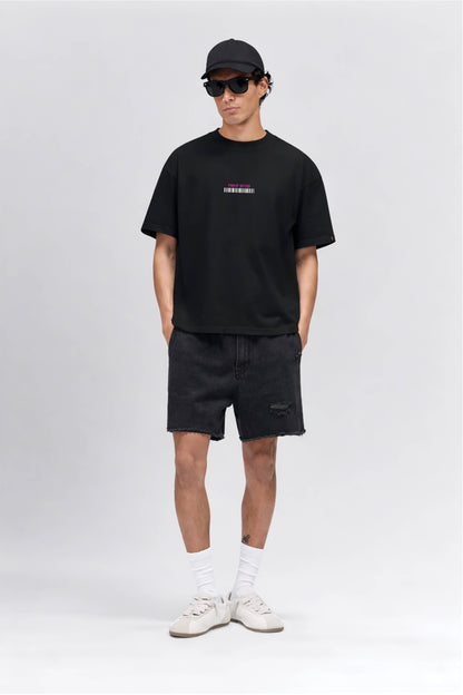 Man wearing a black t-shirt with a logo, black shorts, white sneakers, and a black cap on a white background