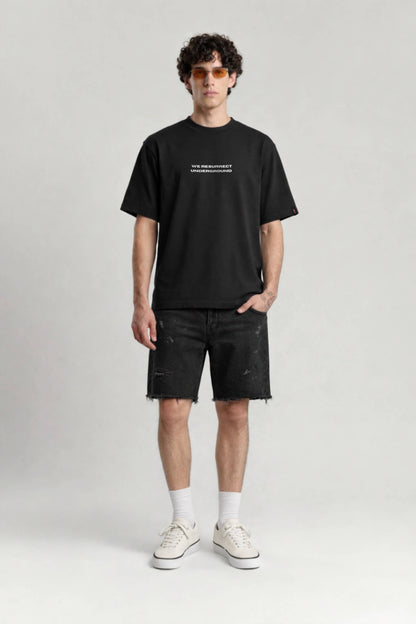 Person wearing a black t-shirt and shorts on a white background