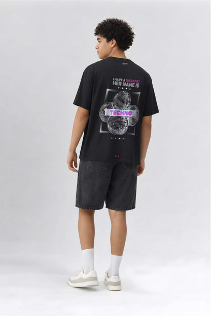 Person wearing a black t-shirt with graphic design on the back against a white background