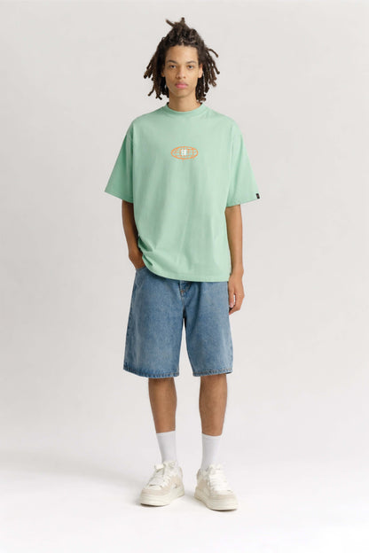 Person wearing a light green t-shirt and blue shorts on a white background