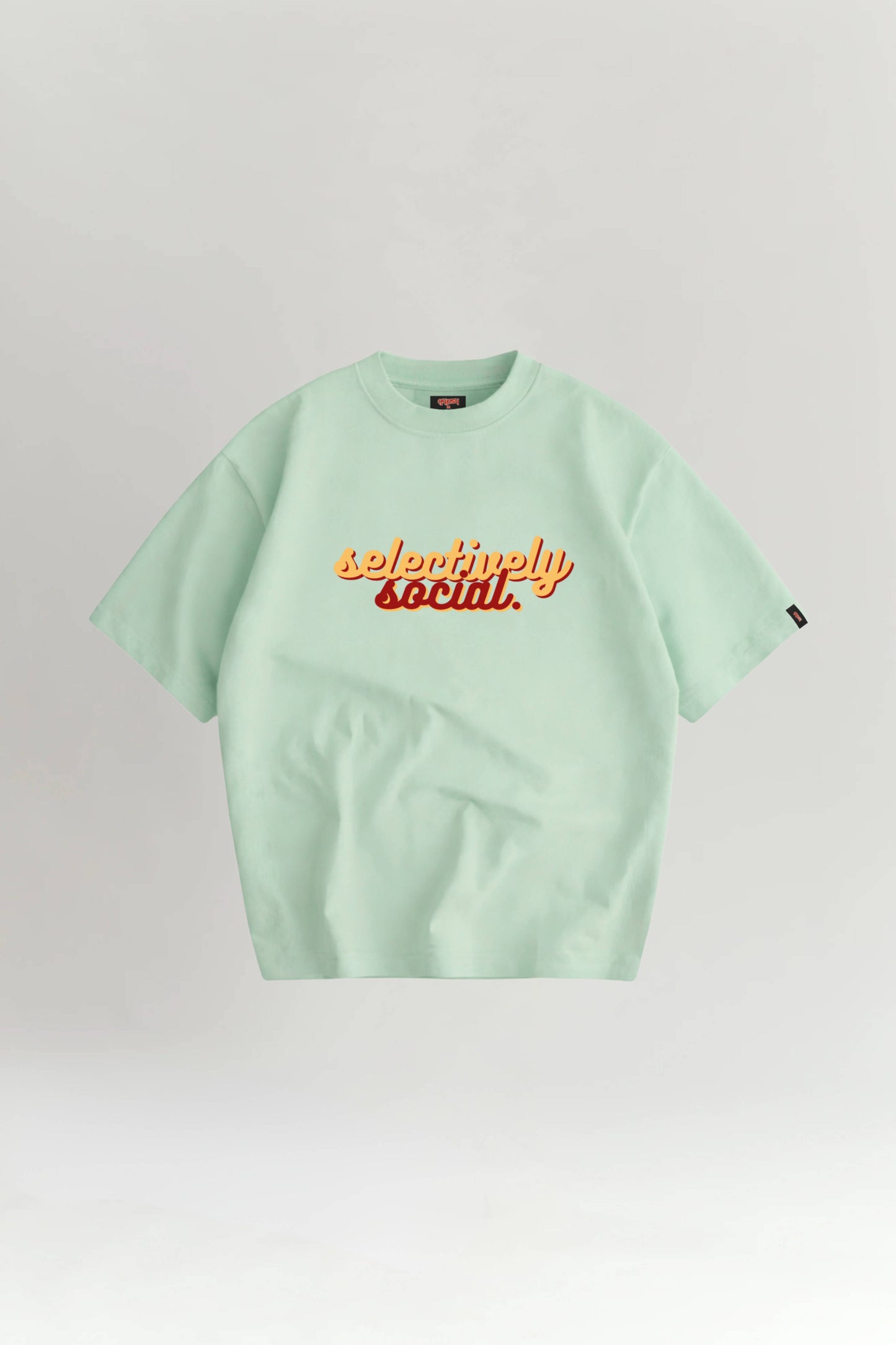 Light green t-shirt with 'selectively social' text on a white background
