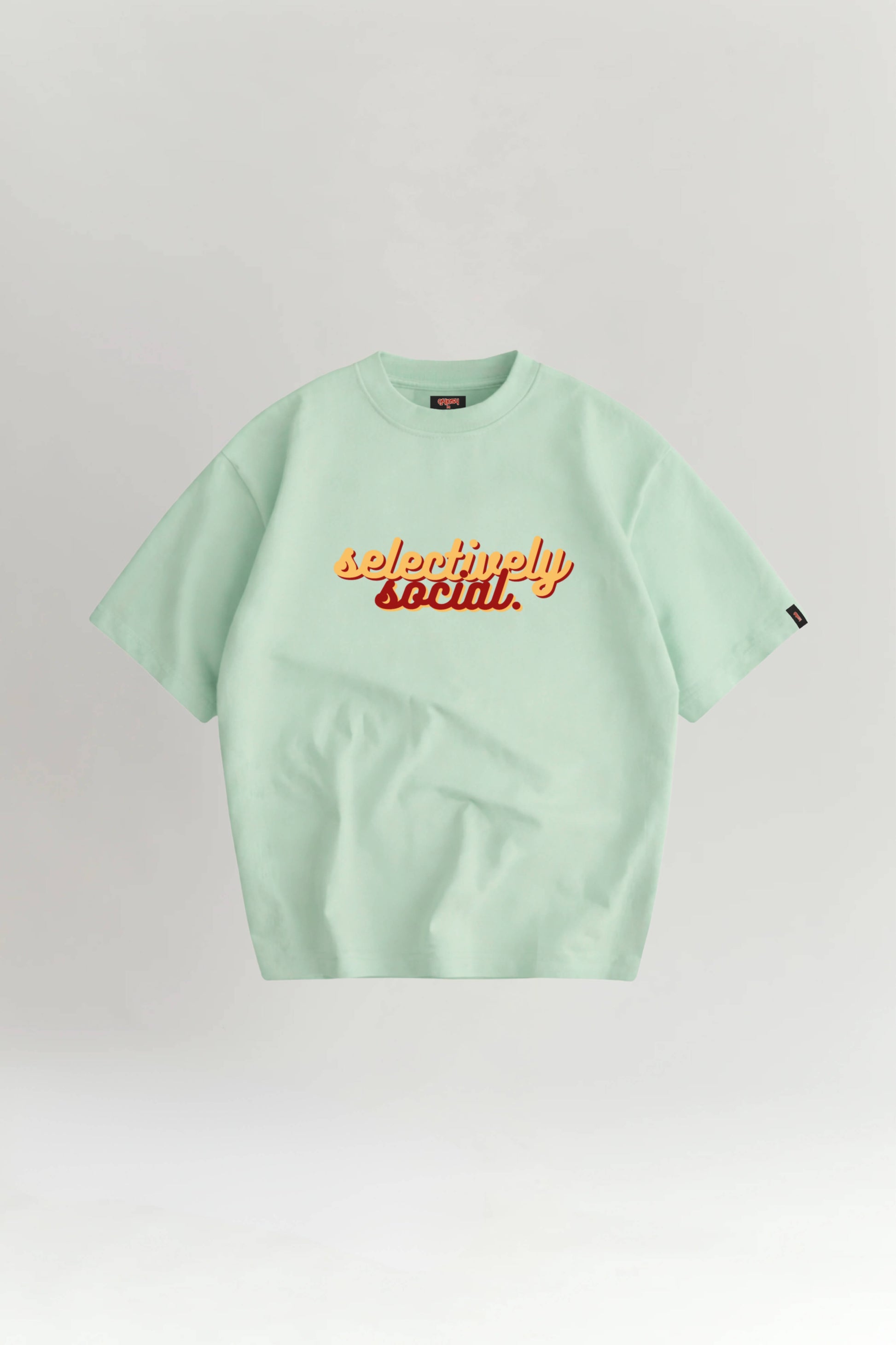 Light green t-shirt with 'selectively social' text on a white background