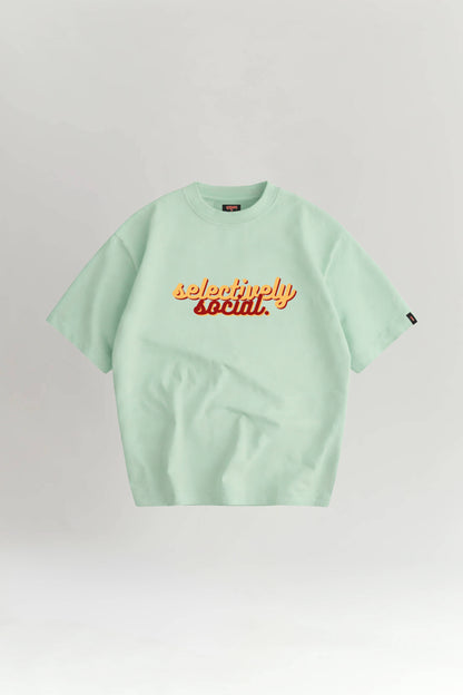 Light green t-shirt with 'selectively social' text on a white background