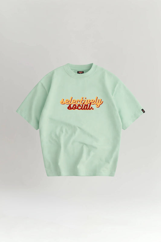 Light green t-shirt with 'selectively social' text on a white background