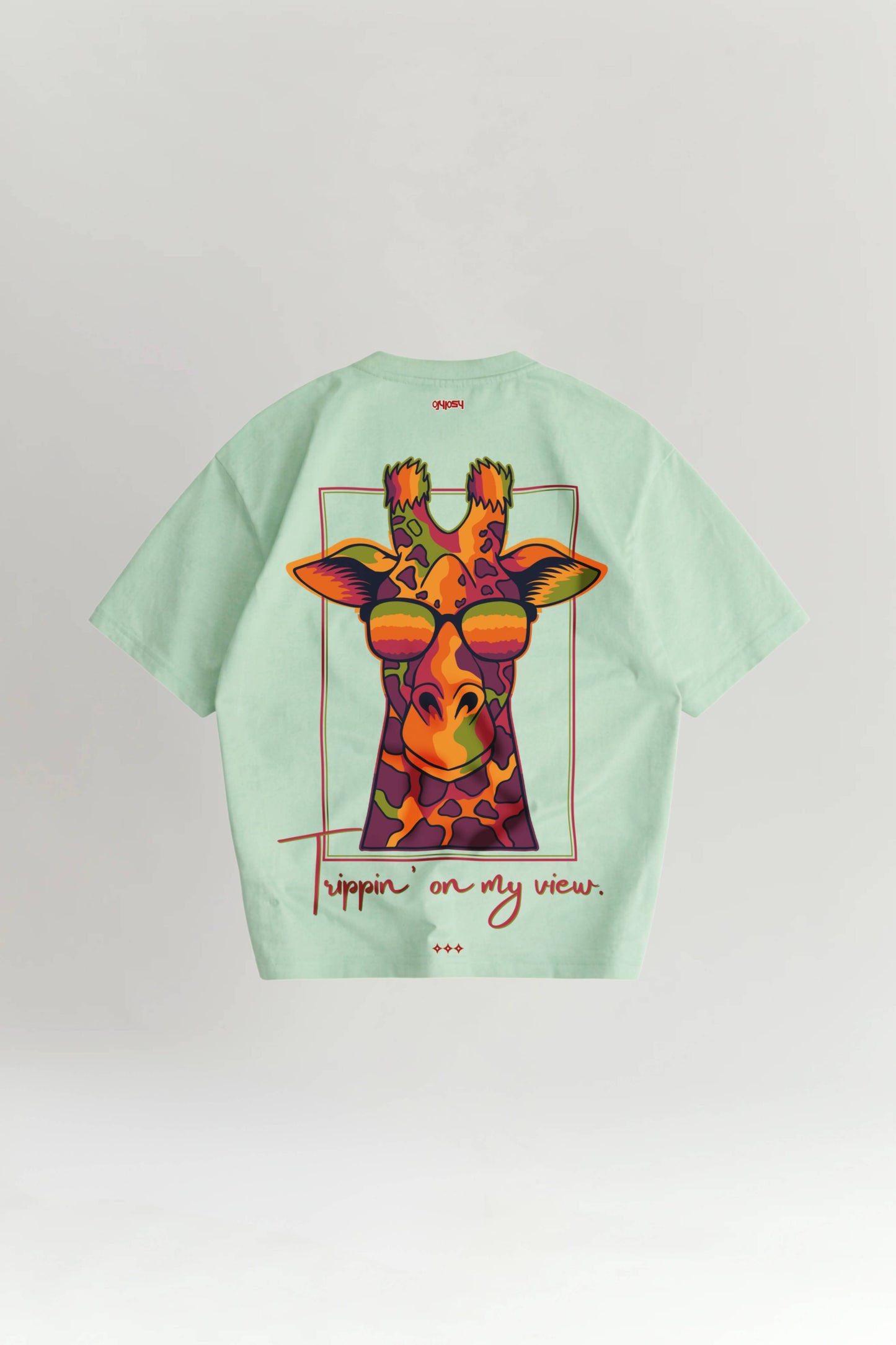 Light green t-shirt with a colorful giraffe graphic and text on a white background